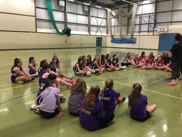 Netball squads receiving their instructions